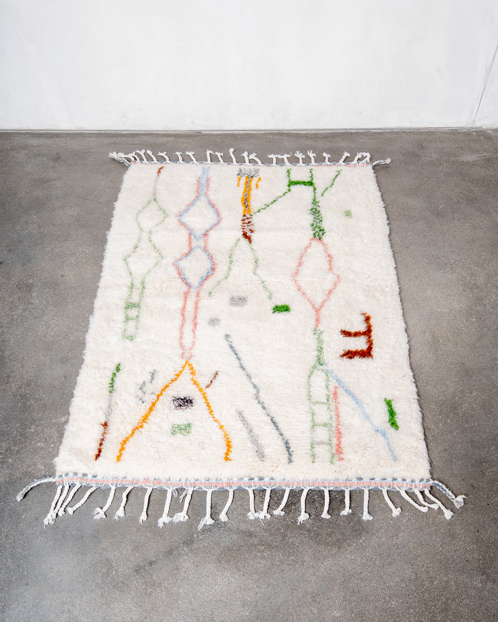 Modern, designer, handcrafted Berber rug from Morocco. Beniourain carpet with beautiful colours and patterns and fluffy wool texture.